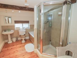a bathroom with a shower and a toilet and a sink at Dunnimere Farmhouse in Tamworth +46 photos