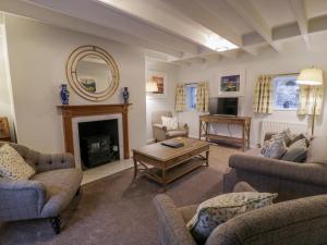 a living room with couches and a fireplace at Blue Door - Kirkcudbright in Kirkcudbright