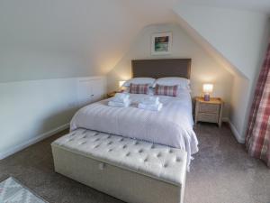 a bedroom with a large bed in a attic at Blue Door - Kirkcudbright in Kirkcudbright