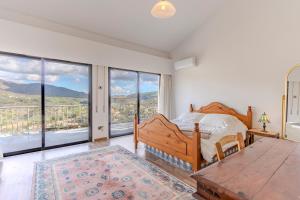 a bedroom with a bed and large windows at Great property - amazing views in Limassol +33 photos