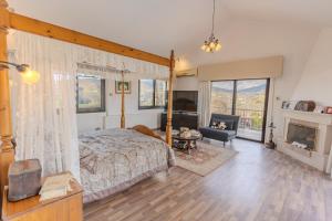 a bedroom with a canopy bed and a fireplace at Great property - amazing views in Limassol