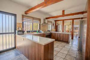 a large kitchen with wooden cabinets and a large window at Great property - amazing views in Limassol