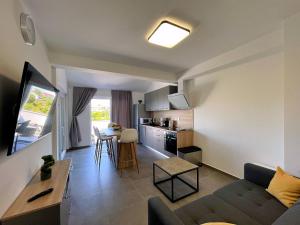 a living room and kitchen with a couch and a table at Apartments Bonum in Šilo