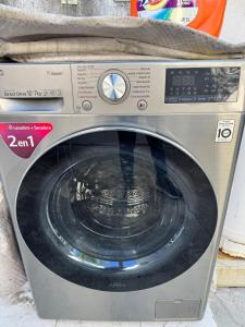 a silver washing machine sitting on top of a counter at Yes's house in Monterrey