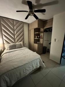 a bedroom with a bed with a ceiling fan at Yes's house in Monterrey