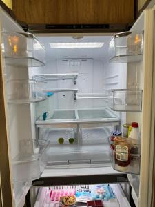 a refrigerator with its door open with food in it at Yes's house in Monterrey