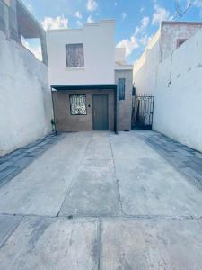 an empty parking lot in front of a building at Yes's house in Monterrey