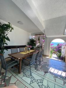 a dining room with a wooden table and chairs at Apartments Nada in Sućuraj