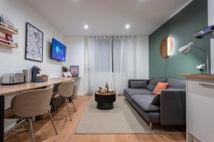 a living room with a couch and a table at Cozy Jacuzzi Bordeaux Chartrons in Bordeaux