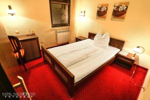Postel nebo postele na pokoji v ubytování Hotel Zodiak
