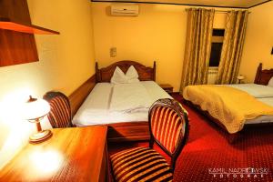 Postel nebo postele na pokoji v ubytování Hotel Zodiak