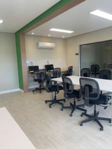 an office with tables and chairs in a room at Smart Convenções in Salvador +6 photos
