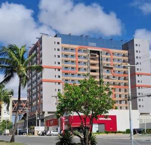 a large apartment building with an orange at Smart Convenções in Salvador