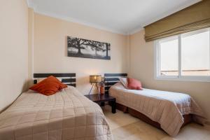 a bedroom with two beds and a window at Penthouse with Jacuzzi by Costarentals - Ref 244 in Fuengirola