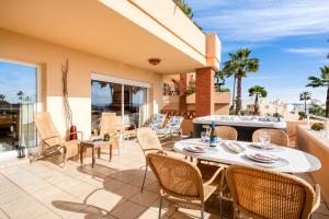 a patio with a table and chairs on a balcony at Penthouse with Jacuzzi by Costarentals - Ref 244 in Fuengirola