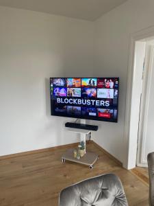 a flat screen tv on a wall in a living room at Homestay - Luxus Ferienwohnung in Bad Griesbach