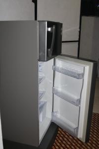 an empty refrigerator with its door open in a room at The Villa Sea Breeze in Talpe