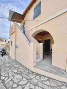 a house with a stairway leading to a door at Kansoneta-Traditional Mansion in Gastouri Village in Gastourion +21 photos