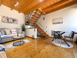 a living room with a couch and a table at Vilia Port House- Corfu Centre in Mantoúkion