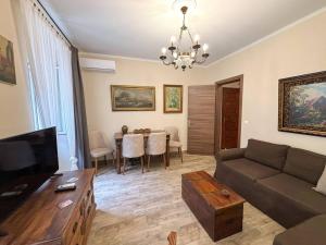 a living room with a couch and a table at Dion and Eva's OldTown Apartment in Corfu Town