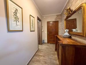 a bathroom with a large mirror and a wooden counter at Dion and Eva's OldTown Apartment in Corfu