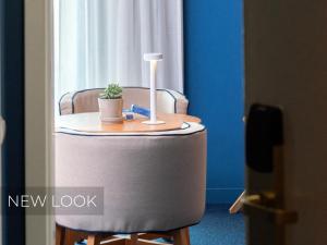 a table with a lamp and a potted plant on it at Velamar Boutique Hotel - Adults Friendly in Albufeira