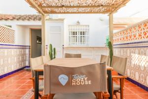 a table and chairs in a room with a house at Tarifa Cozy House - Casita Central in Tarifa