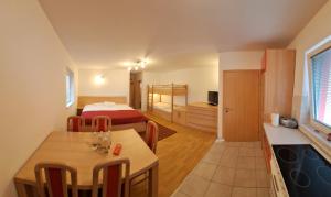 a small room with a bed and a dining table at Apartment Seka in Podčetrtek