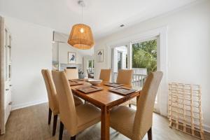 a dining room with a wooden table and chairs at Hellenic Haven home in Georgetown