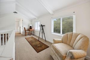 a living room with a chair and a table at Hellenic Haven home in Georgetown +19 photos