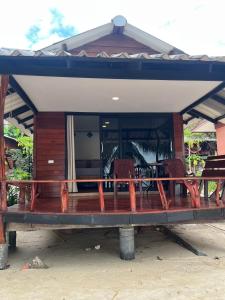 a house on the beach with two chairs at Pimmada Hut in Haad Pleayleam