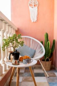 a small table with a basket of croissants on a stairvisorangering at Casa Galicia in El Médano
