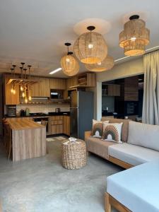 a living room with a couch and a kitchen at Seaesta Milagres in São Miguel dos Milagres
