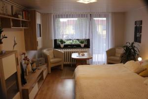 a bedroom with a bed and a table and a window at Inselurlaub in Bergen auf Rügen