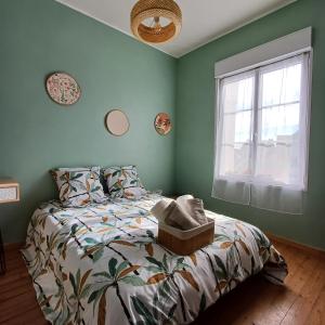 a bedroom with a bed and a window at L'Epicerie Maison années 30 in Caen