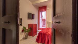 a room with a table and a red refrigerator at Suite Modena al Centro - Affitti Brevi Italia in Modena +11 photos