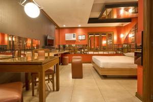 a hotel room with two beds and a dining room at Victoria Court San Fernando in San Fernando +5 photos