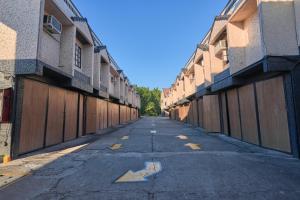 an empty street with wooden gates and an arrow on it at Victoria Court San Fernando in San Fernando