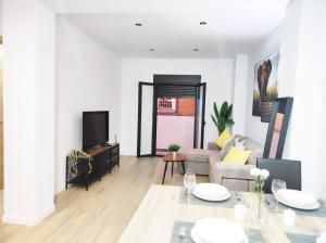 a living room with a couch and a table at Ohana home 2 in Málaga