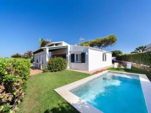 a house with a swimming pool in the yard at Villa Esther vistas al mar Menorca in Cap d'en Font
