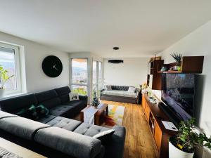 a living room with a couch and a flat screen tv at Rubicon in Poprad
