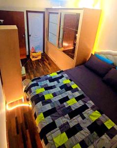 a bedroom with a bed with a quilt on it at River View Active 7 in Bangkok