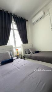 a bedroom with two beds and a window at The Ambiance, Melaka in Malacca +30 photos