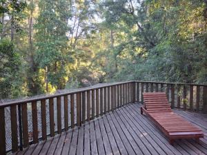 a wooden bench sitting on a wooden deck at Nidos del Chucao in Pucón