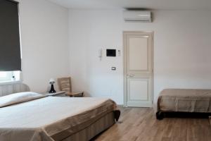 Postel nebo postele na pokoji v ubytování HOUSE AIRPORT Catania