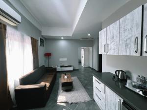 a living room with a couch and a table at Euro Homes Hotel in Accra