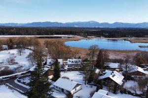 an aerial view of a house and a lake at Gartensee Chalet in Seeshaupt in Seeshaupt