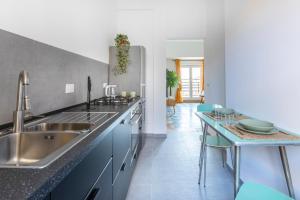 a kitchen with a sink and a counter top at Casa Vespi by Hili in Rome