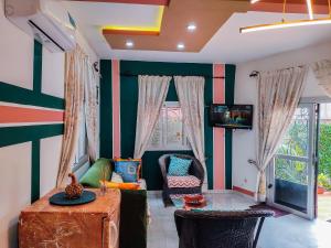 un soggiorno con un divano e una TV di MOOKSQUARE NS SPOT a Douala Altre 11 foto