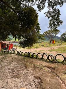 a fence in the middle of a field at Complexo canta galo in São Thomé das Letras